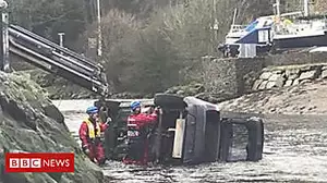 Car pulled from river by crane