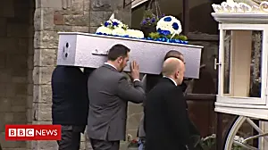 Dead boy's twin rides on funeral carriage